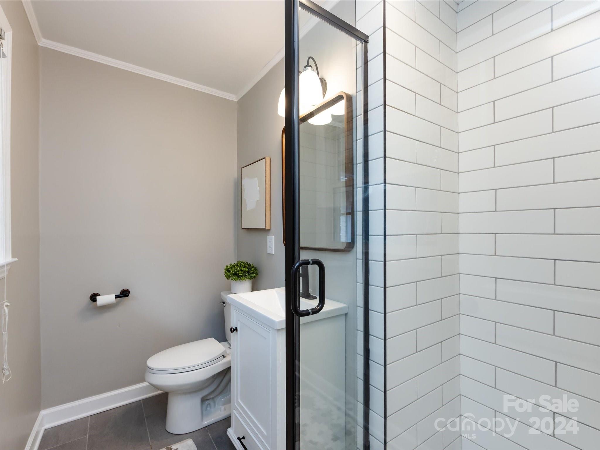 3133 Spring Valley Road Charlotte, NC 28210 - Photo 16 of 25 a bathroom with a toilet and shower