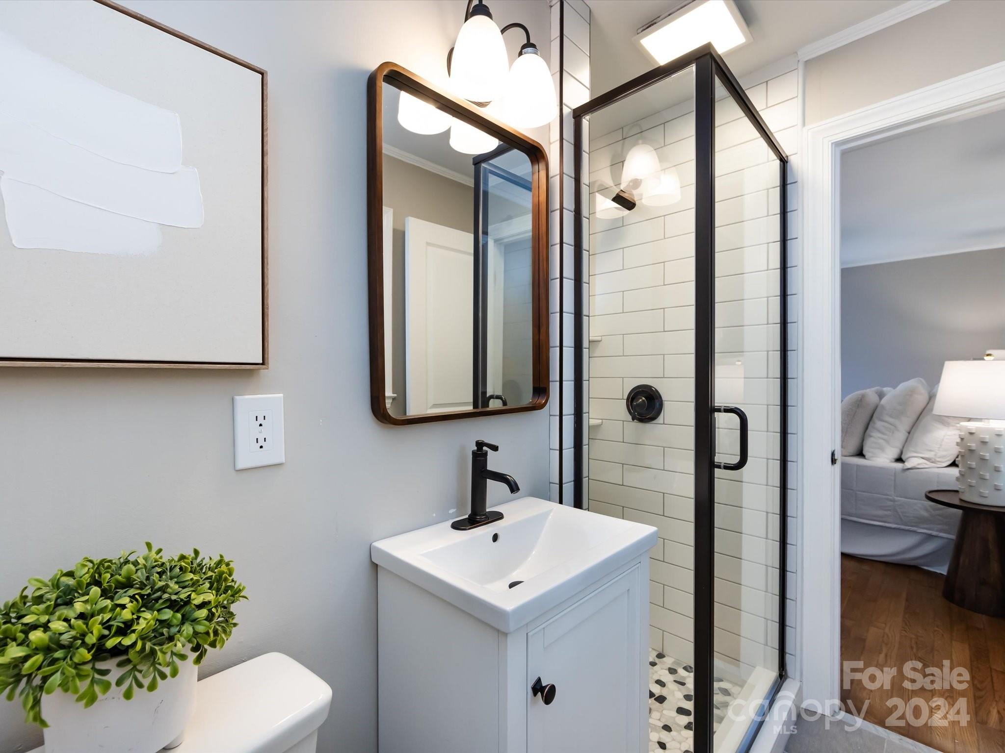 3133 Spring Valley Road Charlotte, NC 28210 - Photo 17 of 25 a bathroom with a sink toilet and shower