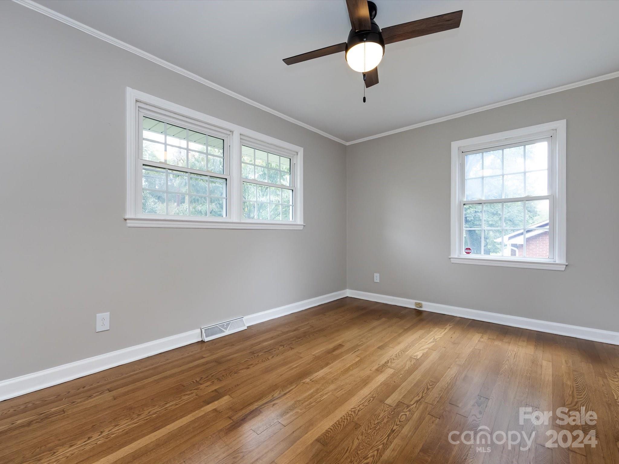 3133 Spring Valley Road Charlotte, NC 28210 - Photo 18 of 25 a view of an empty room with wooden floor and a window