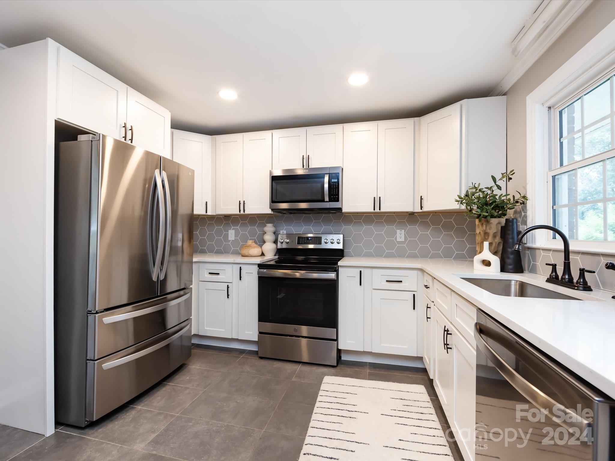 3133 Spring Valley Road Charlotte, NC 28210 - Photo 9 of 25 a kitchen with a refrigerator sink and microwave