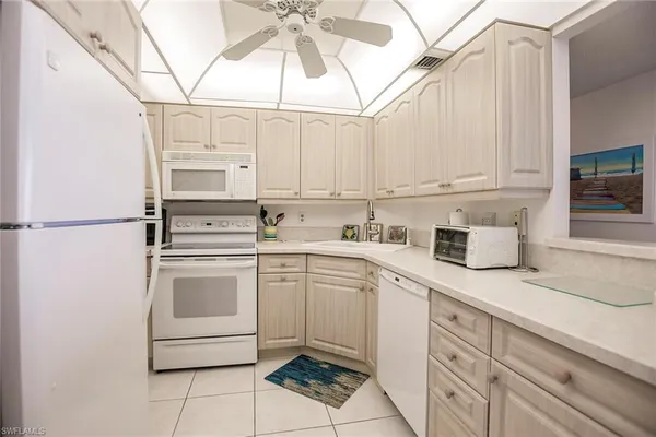 a kitchen with stainless steel appliances granite countertop a sink a stove and cabinets