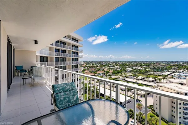 a view of a balcony with chairs