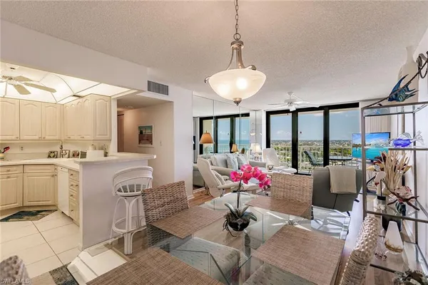 a living room with kitchen and kitchen chandelier