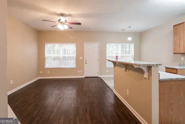 a view of a kitchen with wooden floor and a window