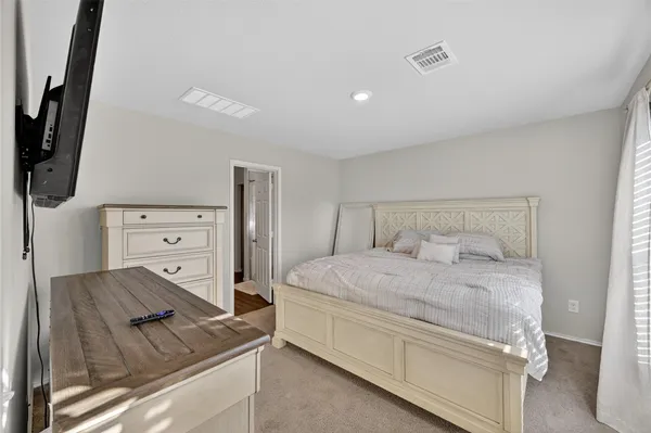 a bedroom with a bed and flat screen tv