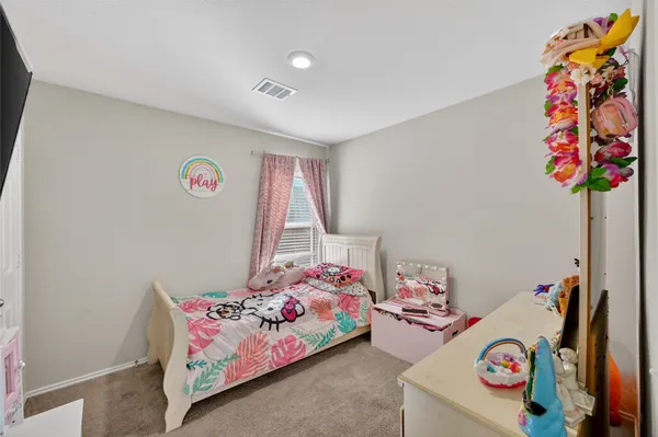 a bedroom with toys and a book shelf