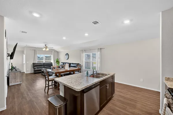 a view of a kitchen with a sink and cabinets