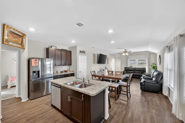 a large kitchen with stainless steel appliances lots of counter top space