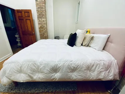 a large white bed in a small room