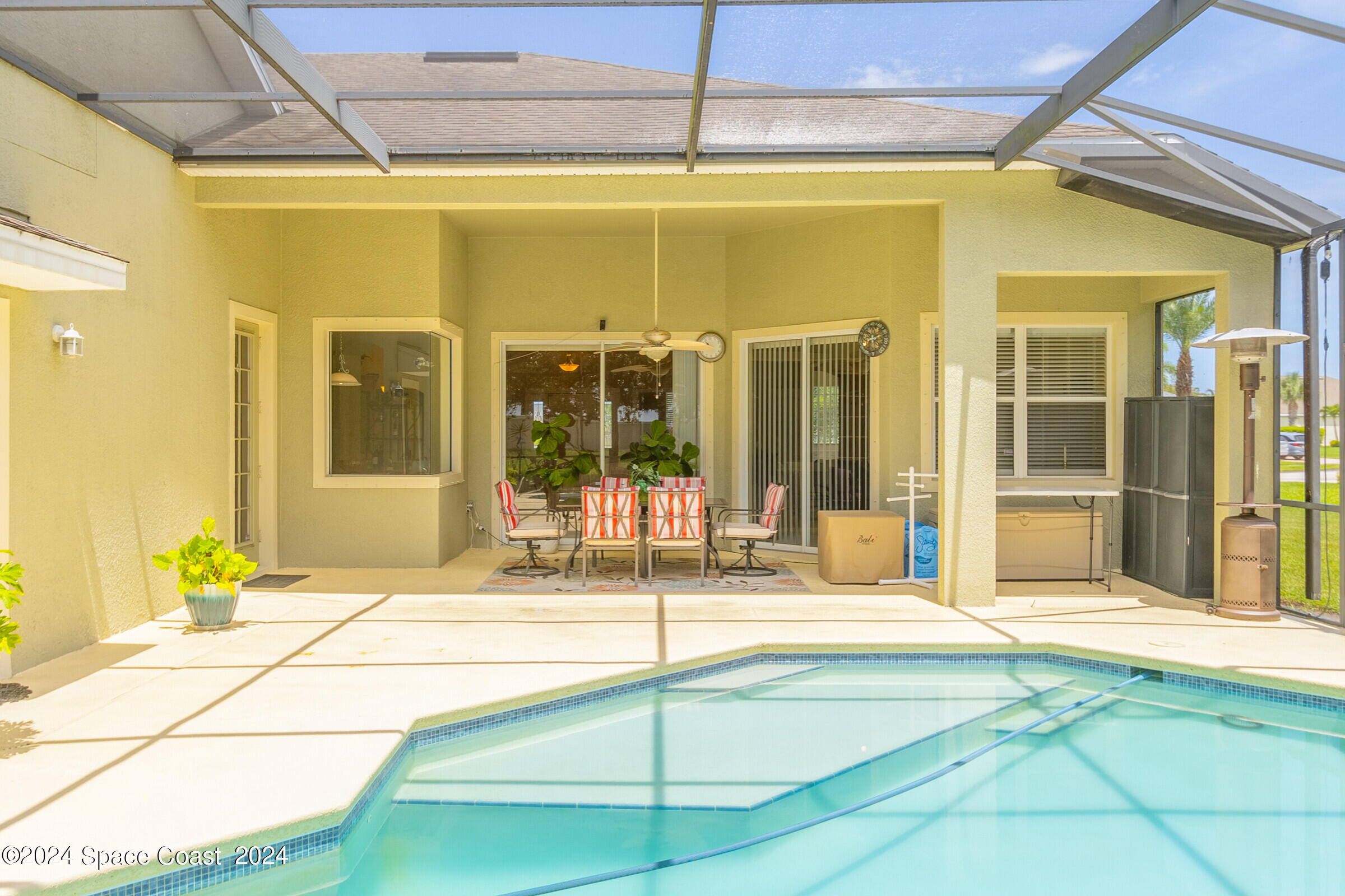 5972 Goleta Circle Melbourne, FL 32940 - Photo 11 of 56 a swimming pool with potted plants