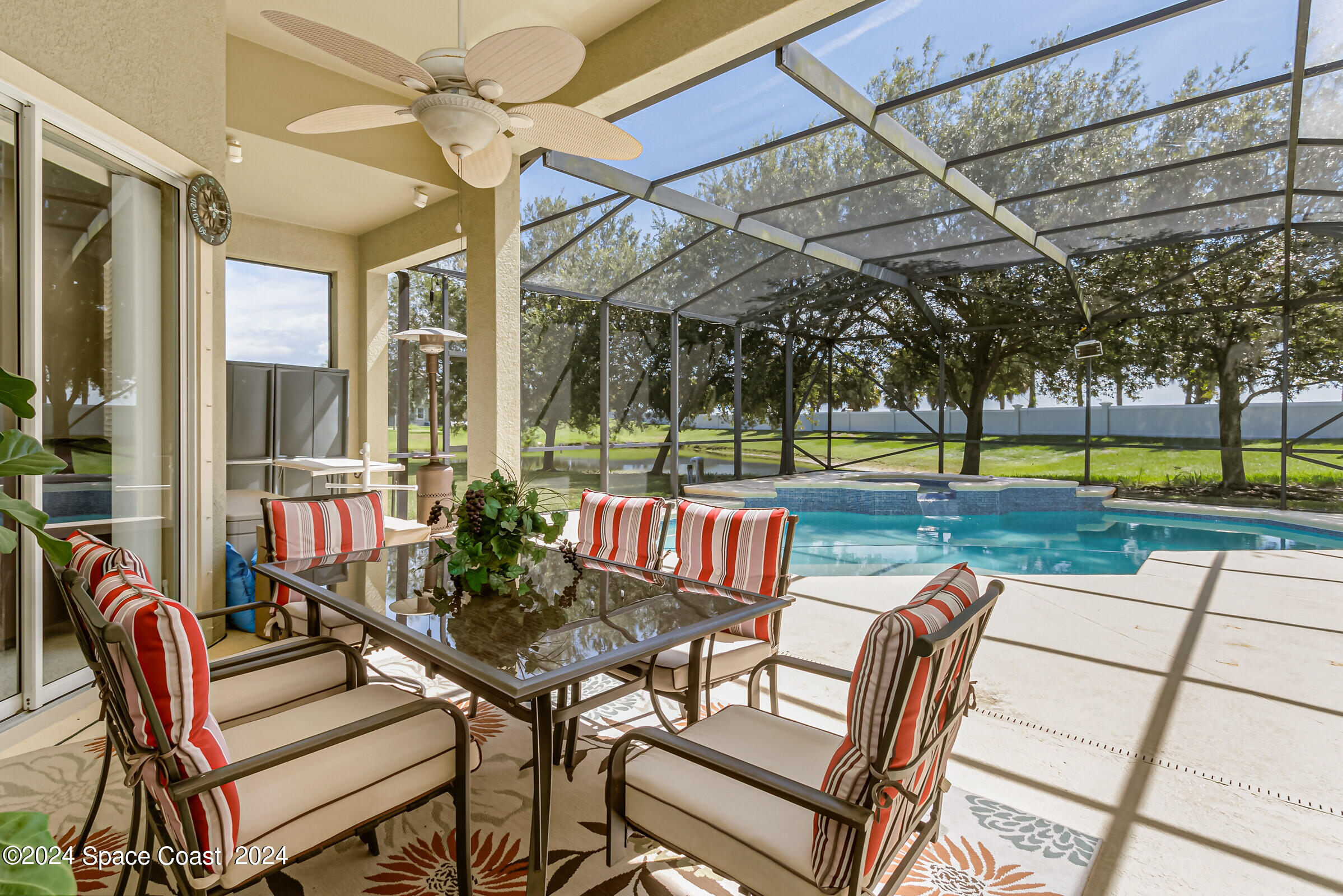 5972 Goleta Circle Melbourne, FL 32940 - Photo 13 of 56 a view of a patio with a table and chairs