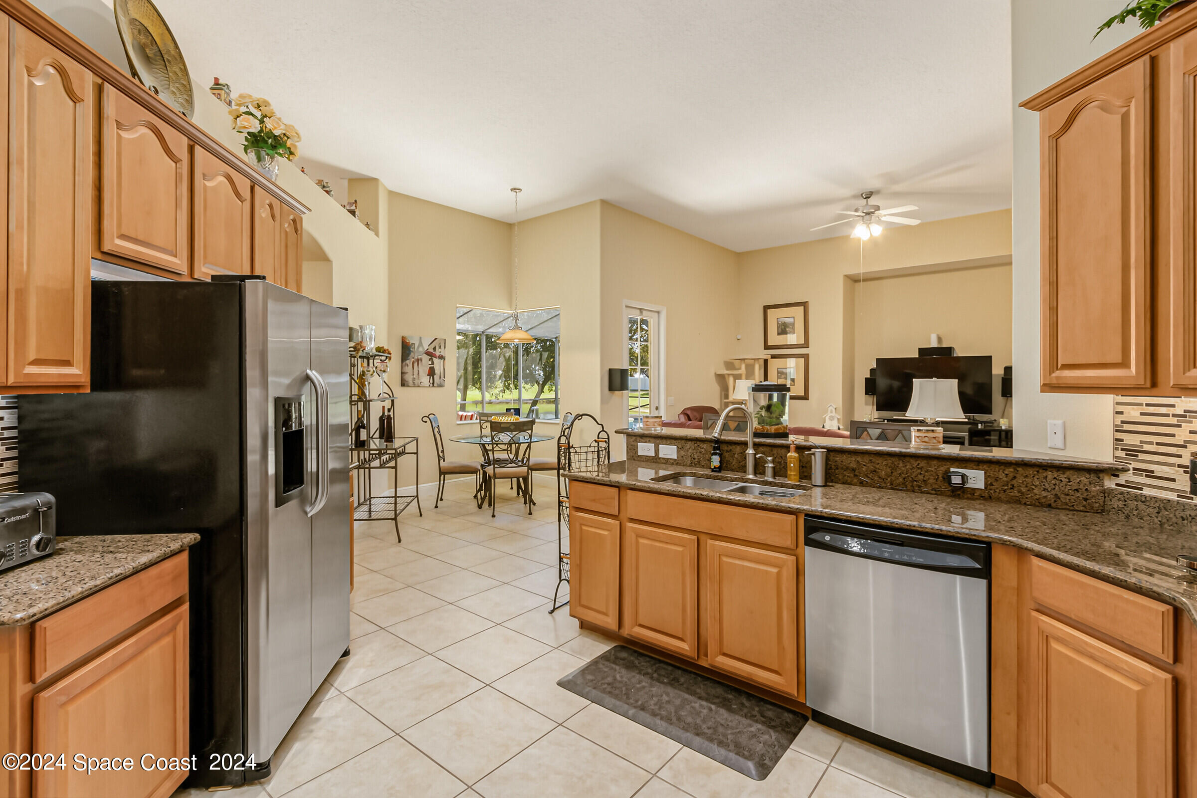5972 Goleta Circle Melbourne, FL 32940 - Photo 25 of 56 a kitchen with stainless steel appliances granite countertop a refrigerator a stove and a sink