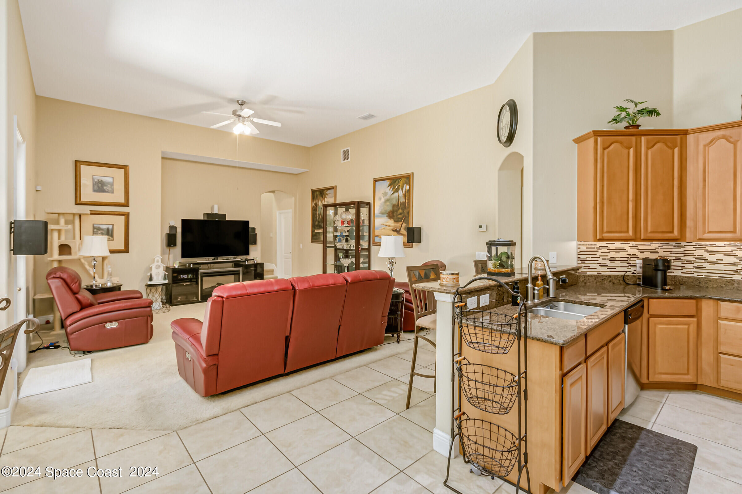 5972 Goleta Circle Melbourne, FL 32940 - Photo 27 of 56 a living room with furniture and a flat screen tv