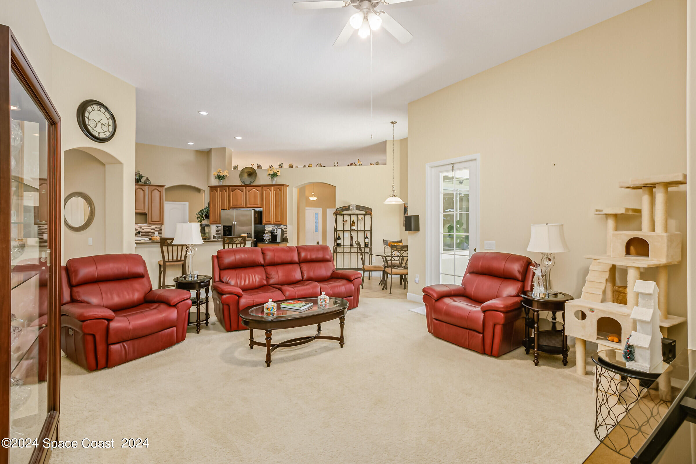 5972 Goleta Circle Melbourne, FL 32940 - Photo 30 of 56 a living room with furniture a fireplace and a flat screen tv
