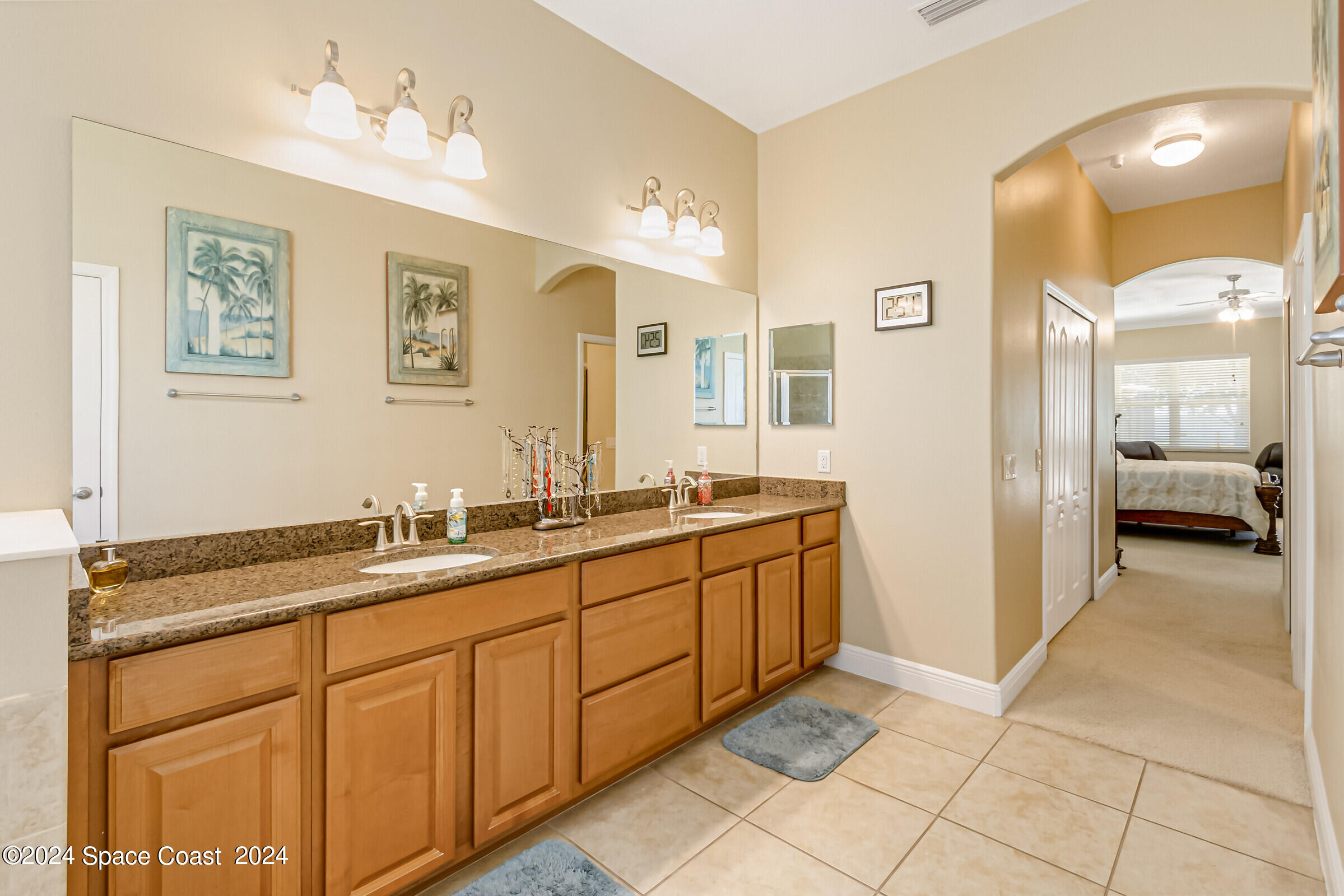 5972 Goleta Circle Melbourne, FL 32940 - Photo 36 of 56 a bathroom with a sink and a mirror