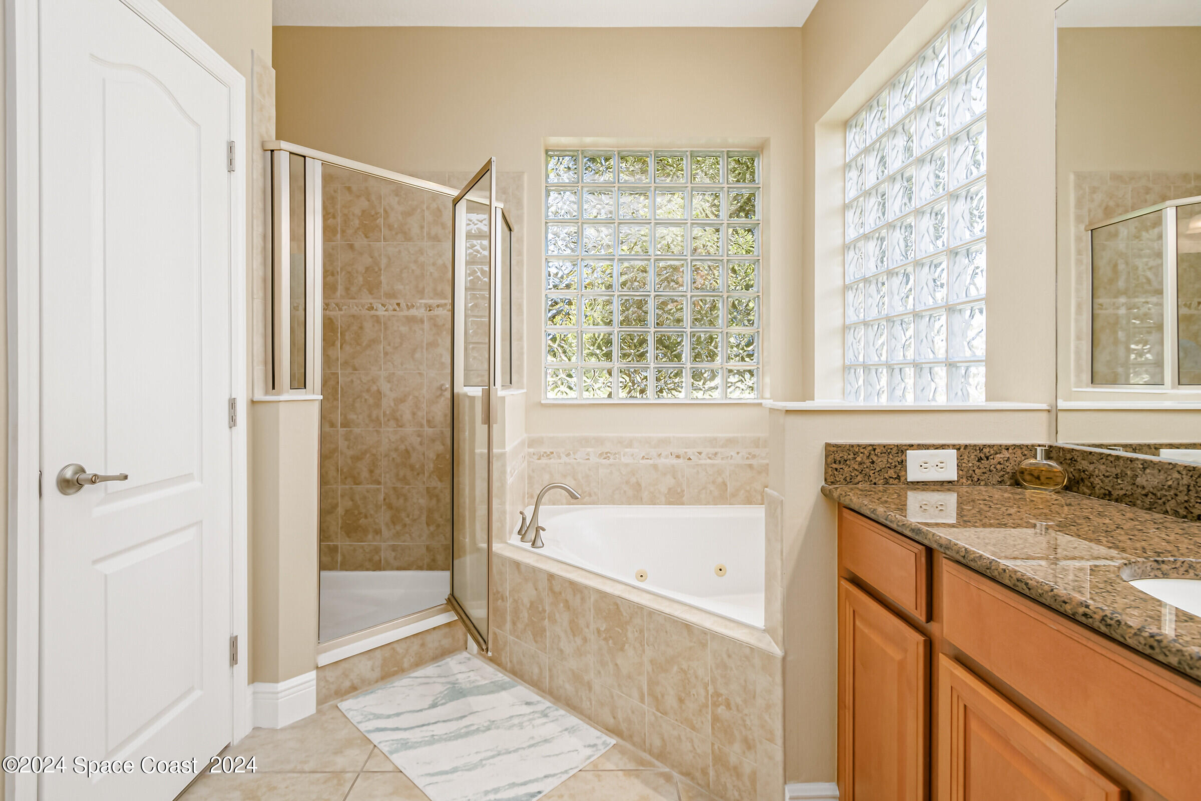 5972 Goleta Circle Melbourne, FL 32940 - Photo 38 of 56 a bathroom with a granite countertop sink and a bathtub