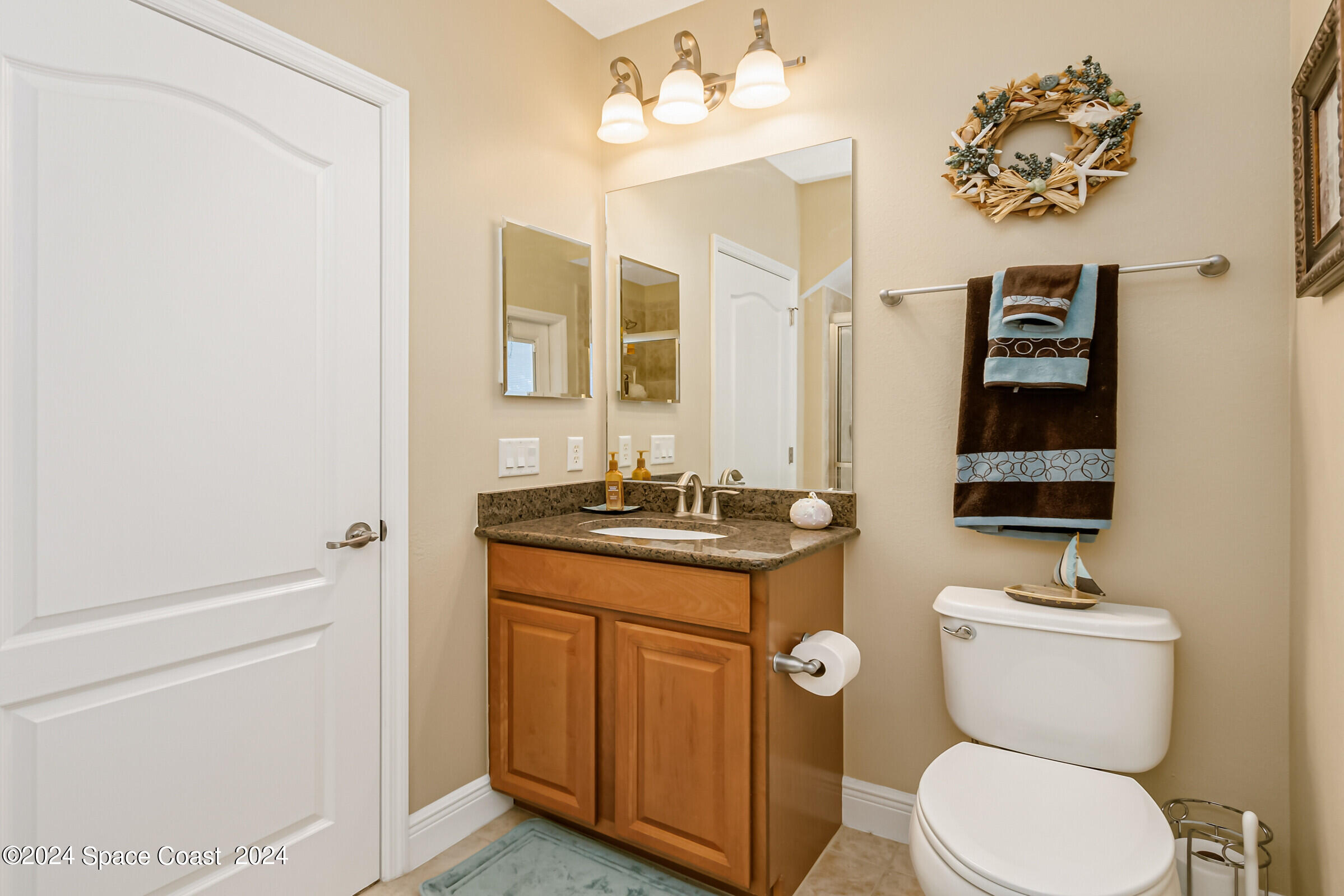 5972 Goleta Circle Melbourne, FL 32940 - Photo 40 of 56 a bathroom with a toilet a sink and mirror