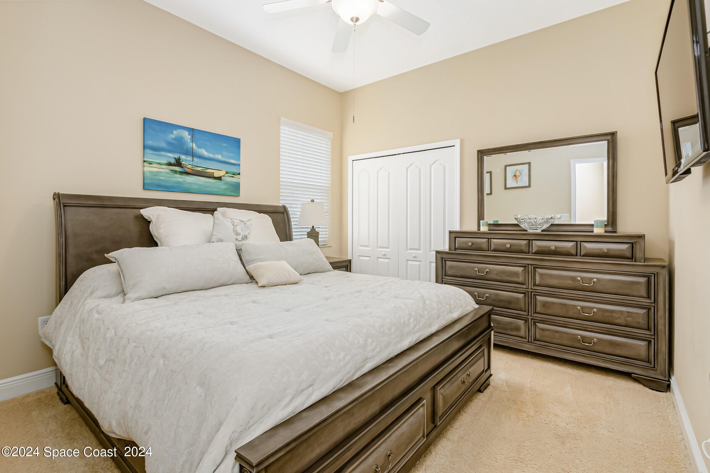 5972 Goleta Circle Melbourne, FL 32940 - Photo 45 of 56 a bedroom with a bed and a chandelier