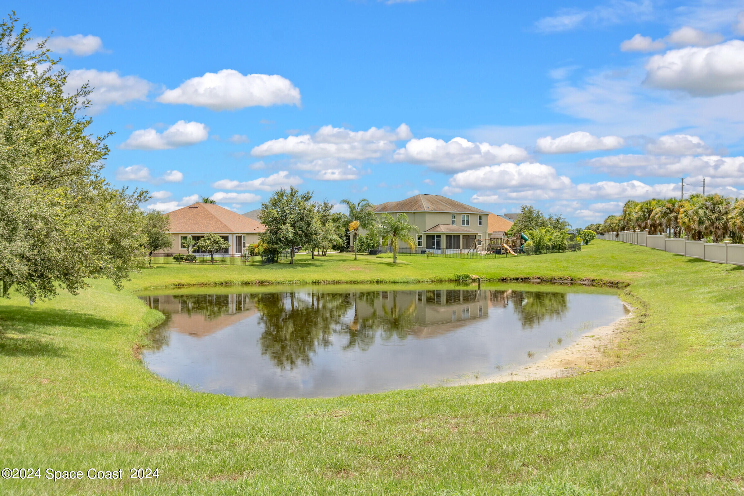 5972 Goleta Circle Melbourne, FL 32940 - Photo 5 of 56 a view of a lake with a yard