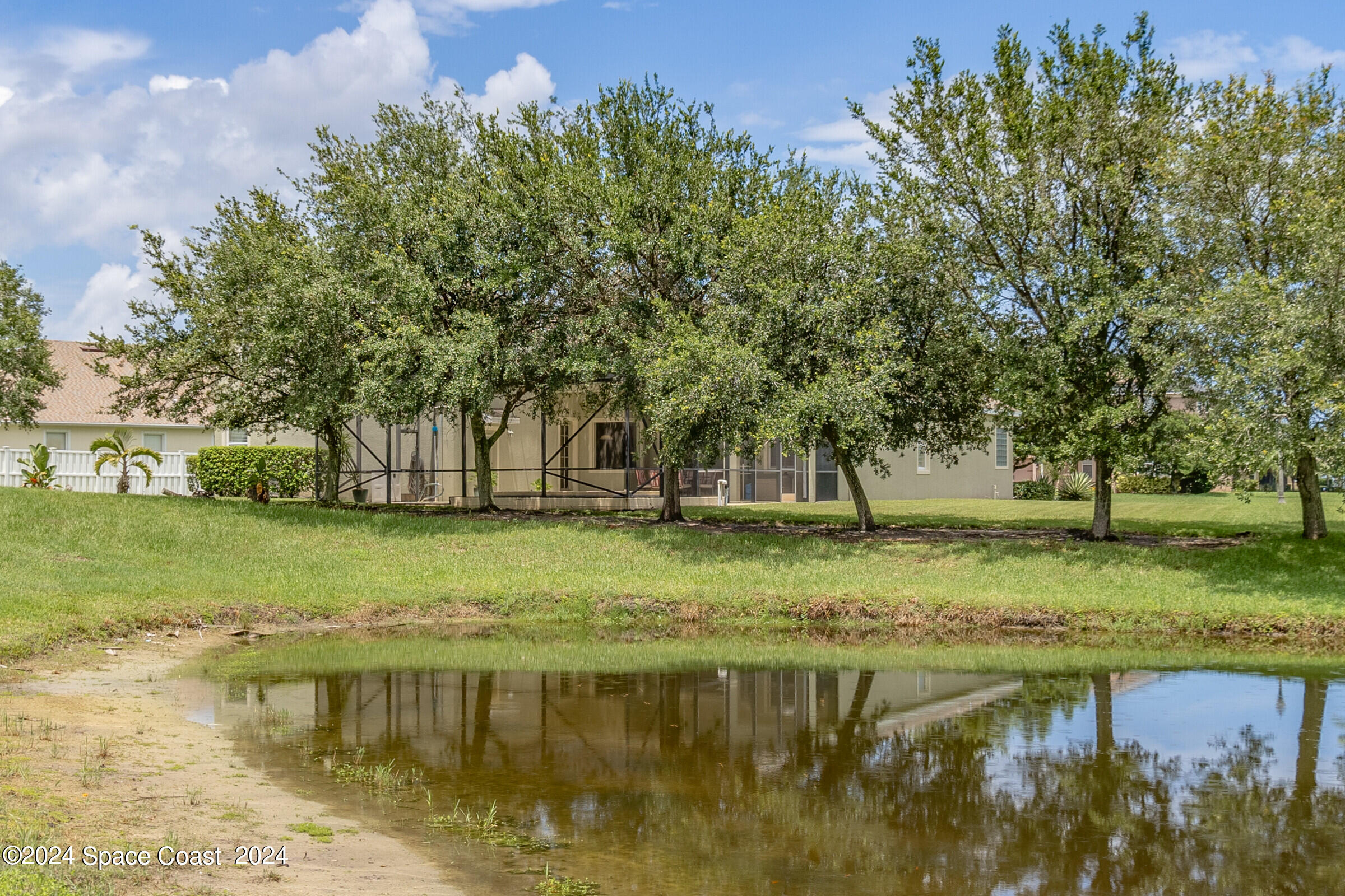 5972 Goleta Circle Melbourne, FL 32940 - Photo 6 of 56 a view of a lake with houses