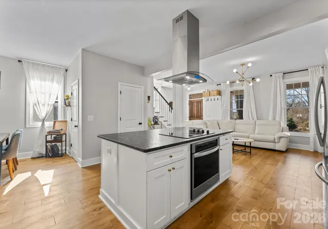 a kitchen with stainless steel appliances a sink stove and cabinets
