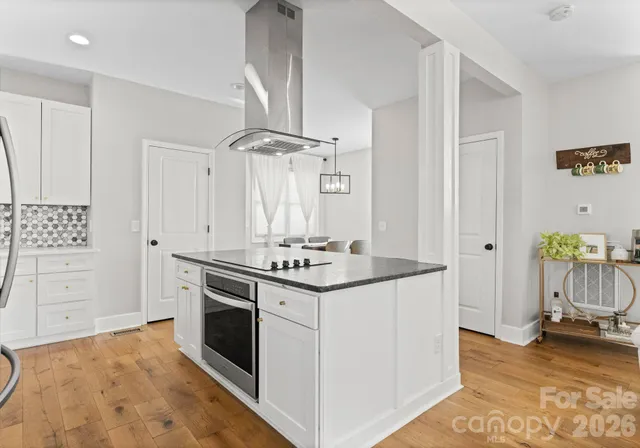 a kitchen with granite countertop a stove and a sink