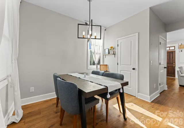 a view of a dining room with a table and chairs
