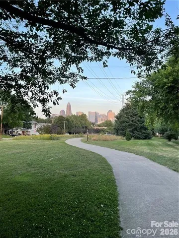 a view of a field of grass and trees