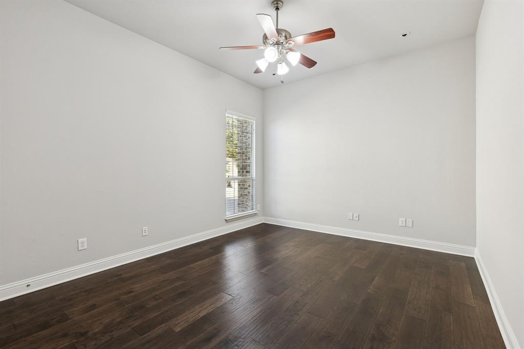2816 Mona Vale Road Trophy Club, TX 76262 - Photo 22 of 40 an empty room with wooden floor and fan