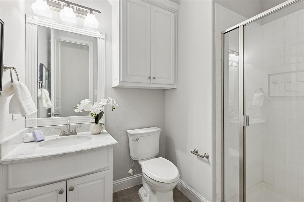 2816 Mona Vale Road Trophy Club, TX 76262 - Photo 23 of 40 a bathroom with a granite countertop sink toilet and shower