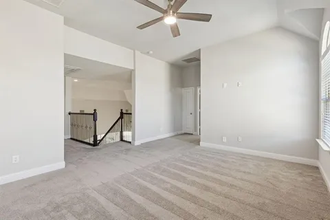 an empty room with closet and a ceiling fan