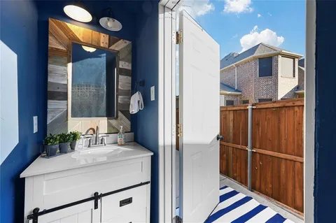 a front view of a house with garden and trees