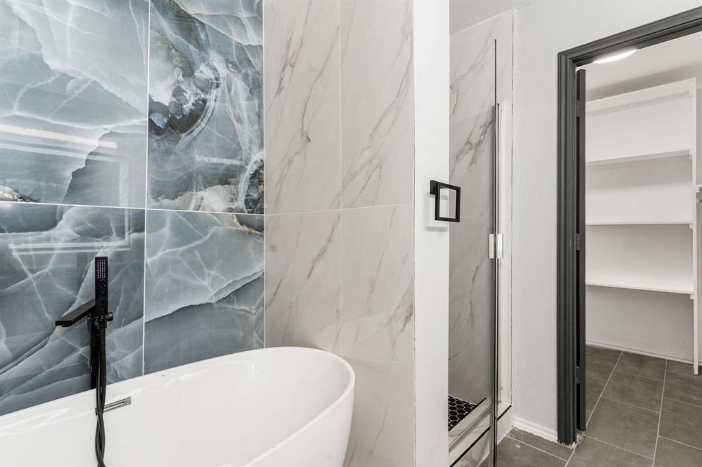 4529 Martingale View Lane Fort Worth, TX 76244 - Photo 11 of 38 a bathroom with a bathtub and shower