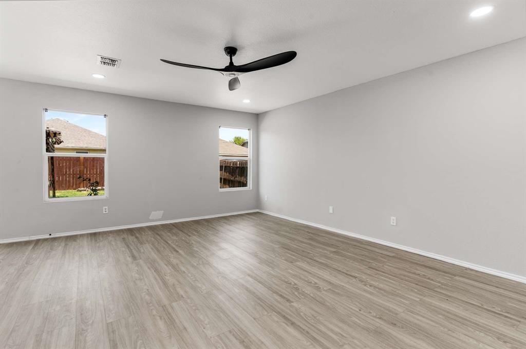 4529 Martingale View Lane Fort Worth, TX 76244 - Photo 13 of 38 a view of an empty room with a window and wooden floor