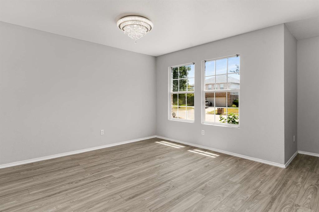 4529 Martingale View Lane Fort Worth, TX 76244 - Photo 16 of 38 wooden floor in an empty room with a window