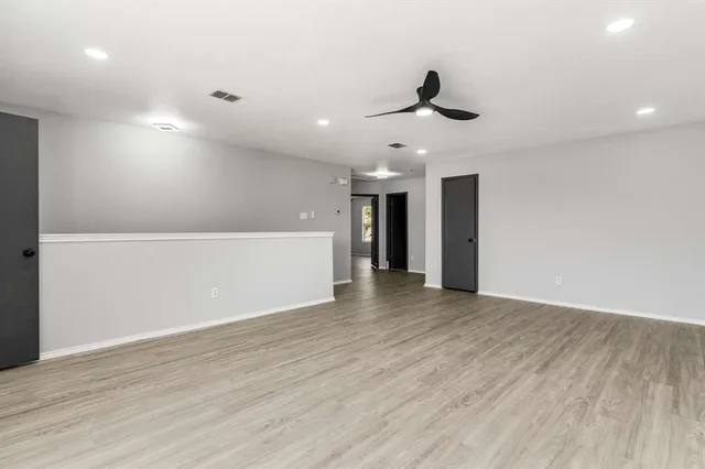 a view of an empty room with a kitchen