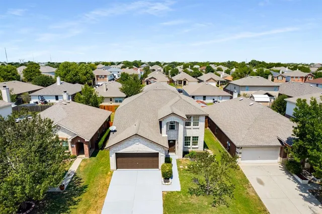 an aerial view of a house with a yard