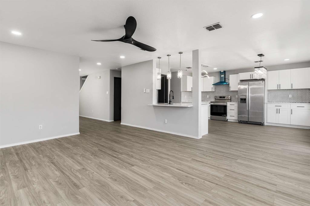 4529 Martingale View Lane Fort Worth, TX 76244 - Photo 4 of 38 a view of a kitchen with stainless steel appliances a refrigerator stove top oven and cabinets