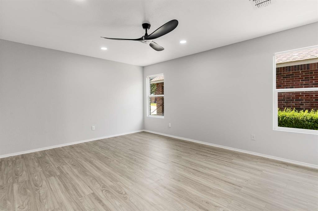 4529 Martingale View Lane Fort Worth, TX 76244 - Photo 6 of 38 wooden floor in an empty room with a window