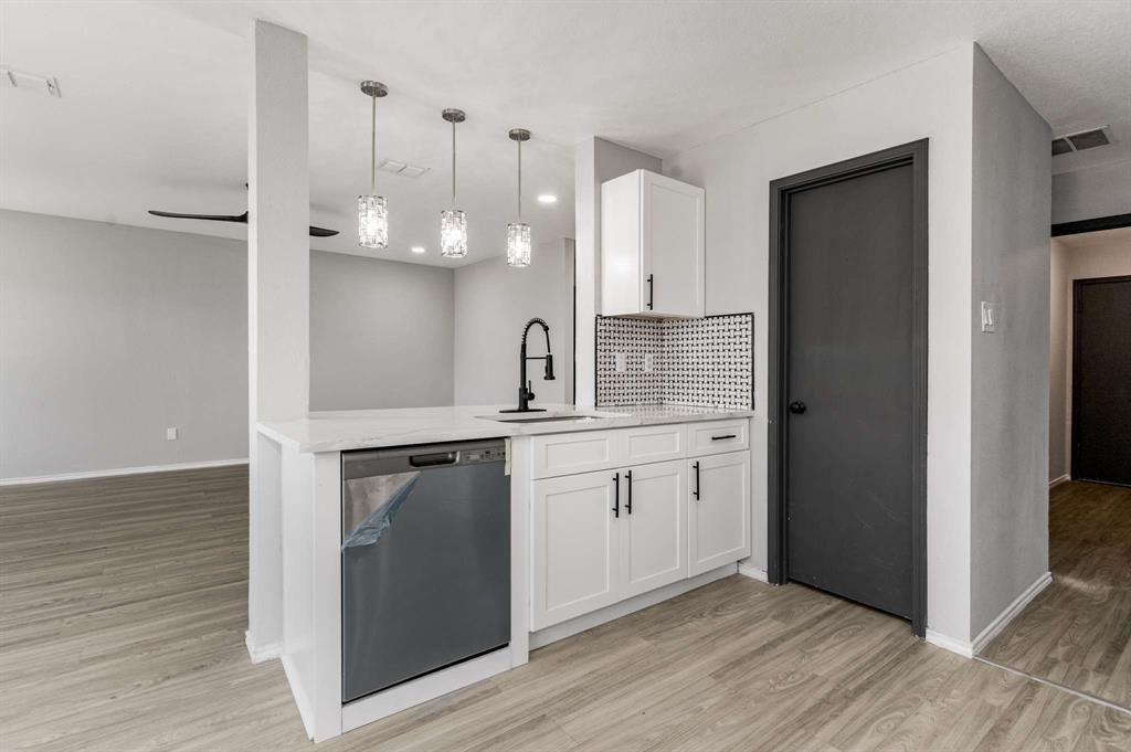 4529 Martingale View Lane Fort Worth, TX 76244 - Photo 8 of 38 a kitchen with a sink cabinets and wooden floor