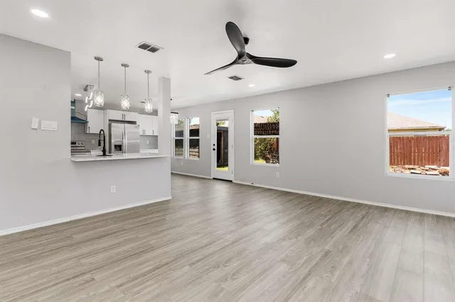 a view of a kitchen with stainless steel appliances granite countertop cabinets and wooden floor