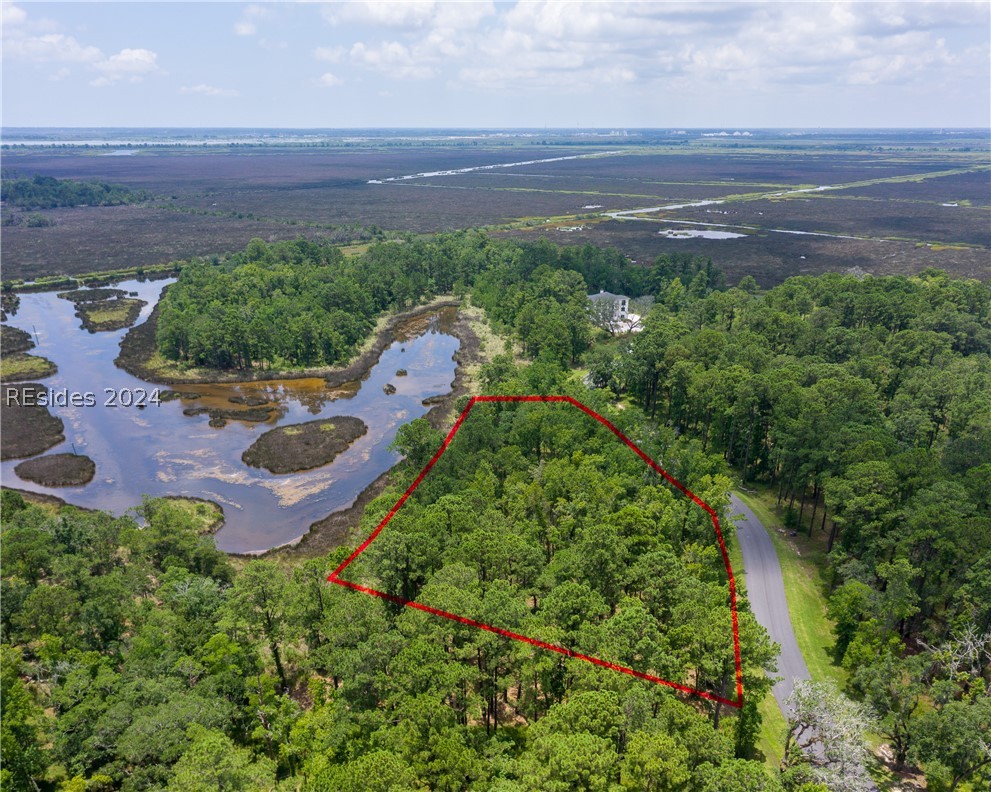 859 Bridle Path Boulevard Hardeeville, SC 29927 - Photo 17 of 40 Aerial view of Lot 27, the magnificent water/marsh views beyond and the frontage along Bridle Path Road. This pond was once part of the historic rice fields of the south. Now it is a place to observe resident shore birds and stunning sunrises to the east.
