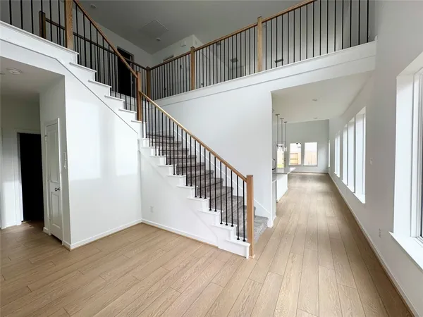 a view of staircase with wooden floor and a floor to ceiling window
