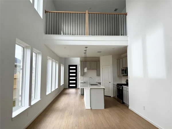 a view of a kitchen with a sink and a refrigerator