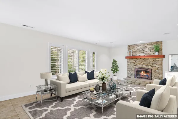 a living room with furniture a fireplace and a table