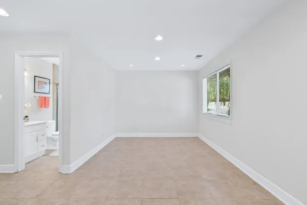 an empty room with a window and a ceiling fan