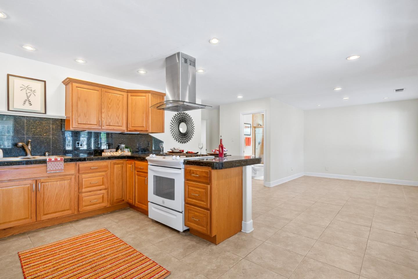 3373 Allred Lane Soquel, CA 95073 - Photo 21 of 31 a kitchen with stainless steel appliances granite countertop a sink a stove and a wooden floors