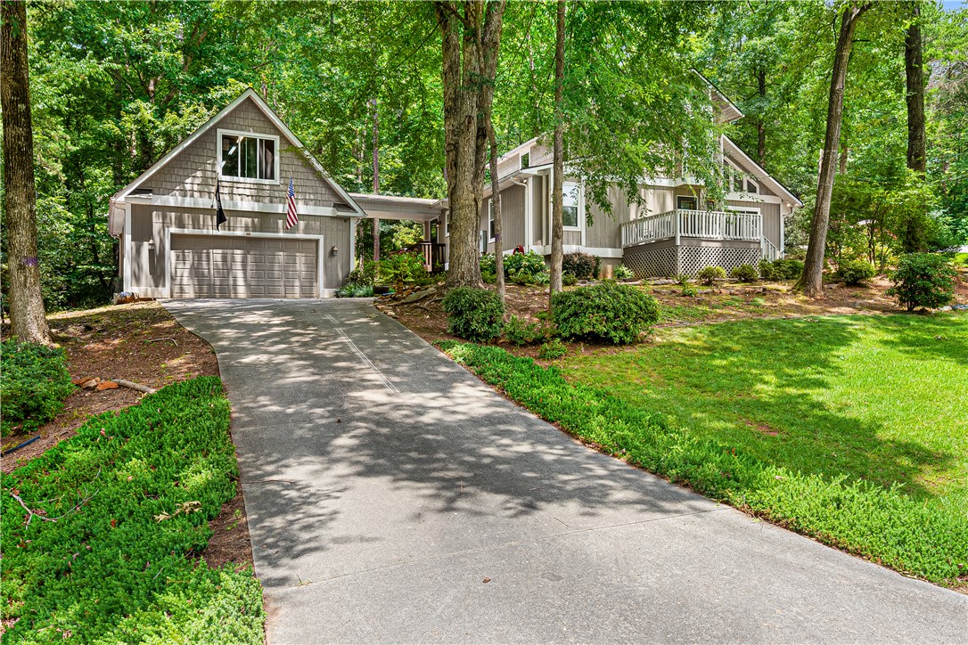 139 Tulip Lane Westminster, SC 29693 - Photo 1 of 37 A private driveway leads to this sylvan home, nestled among verdant trees and abundant landscaping.