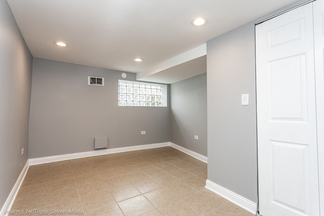 447 West 81st Street, Unit G Chicago, IL 60620 - Photo 12 of 20 a view of an empty room with a window