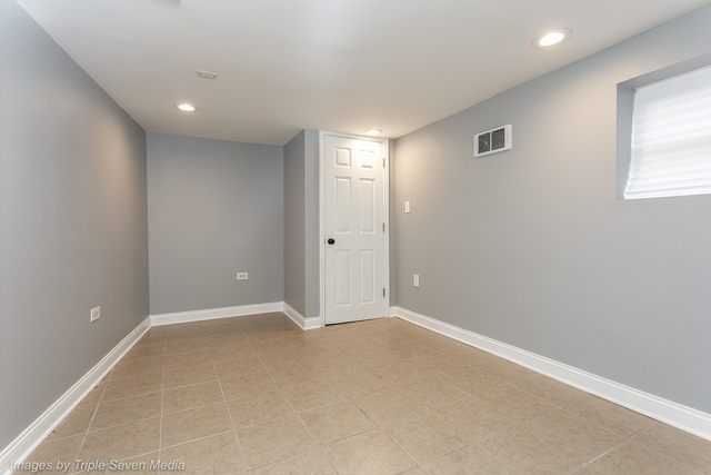 447 West 81st Street, Unit G Chicago, IL 60620 - Photo 15 of 20 an empty room with windows and closet